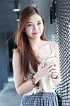 Portrait Of Thai Adult Beautiful Girl Using Her Smart Phone And Smile Stock Photo