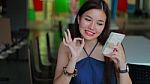 Portrait Of Thai Adult Beautiful Girl Using Her Smart Phone And Smile Stock Photo