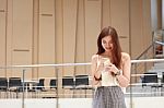 Portrait Of Thai Adult Beautiful Girl Using Her Smart Phone And Smile Stock Photo