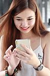 Portrait Of Thai Adult Beautiful Girl Using Her Smart Phone And Smile Stock Photo