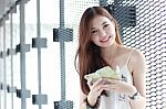 Portrait Of Thai Adult Beautiful Girl Using Her Smart Phone And Smile Stock Photo