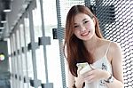 Portrait Of Thai Adult Beautiful Girl Using Her Smart Phone And Smile Stock Photo