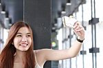 Portrait Of Thai Adult Beautiful Girl Using Her Smart Phone Selfie Stock Photo