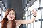 Portrait Of Thai Adult Beautiful Girl Using Her Smart Phone Selfie Stock Photo