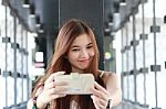 Portrait Of Thai Adult Beautiful Girl Using Her Smart Phone Selfie Stock Photo