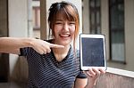 Portrait Of Thai Adult Beautiful Girl Using Her Tablet Stock Photo