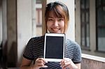 Portrait Of Thai Adult Beautiful Girl Using Her Tablet Stock Photo