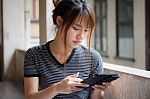 Portrait Of Thai Adult Beautiful Girl Using Her Tablet Stock Photo