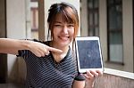 Portrait Of Thai Adult Beautiful Girl Using Her Tablet Stock Photo