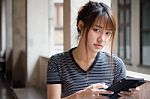 Portrait Of Thai Adult Beautiful Girl Using Her Tablet Stock Photo