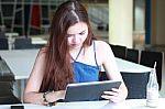 Portrait Of Thai Adult Beautiful Girl Using Her Tablet And Smile In University Stock Photo