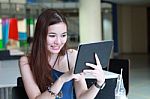 Portrait Of Thai Adult Beautiful Girl Using Her Tablet And Smile In University Stock Photo