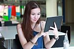 Portrait Of Thai Adult Beautiful Girl Using Her Tablet And Smile In University Stock Photo