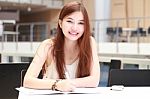 Portrait Of Thai Adult Beautiful Girl Write A Book And Smile In University Stock Photo