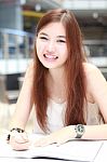 Portrait Of Thai Adult Beautiful Girl Write A Book And Smile In University Stock Photo