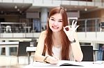 Portrait Of Thai Adult Beautiful Girl Write A Book And Smile In University Stock Photo