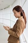 Portrait Of Thai Adult Businesswoman Beautiful Girl Using Her Smart Phone Stock Photo