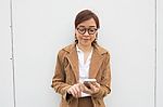 Portrait Of Thai Adult Businesswoman Beautiful Girl Using Her Smart Phone Stock Photo