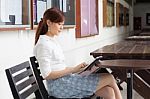 Portrait Of Thai Adult Businesswoman Beautiful Girl Using Her Tablet Stock Photo