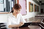 Portrait Of Thai Adult Businesswoman Beautiful Girl Using Her Tablet Stock Photo