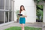 Portrait Of Thai Adult Businesswoman Beautiful Girl Using Her Tablet Stock Photo