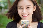 Portrait Of Thai Adult Student University Beautiful Girl Using Her Smart Phone Stock Photo