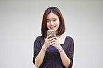 Portrait Of Thai Adult Student University Beautiful Girl Using Her Smart Phone Stock Photo