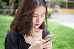 Portrait Of Thai Adult Student University Beautiful Girl Using Her Smart Phone Stock Photo