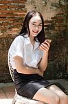 Portrait Of Thai Adult Student University Beautiful Girl Using Her Smart Phone Stock Photo