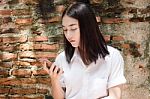 Portrait Of Thai Adult Student University Beautiful Girl Using Her Smart Phone Stock Photo