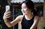 Portrait Of Thai Adult Student University Beautiful Girl Using Her Smart Phone Selfie Stock Photo