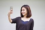 Portrait Of Thai Adult Student University Beautiful Girl Using Her Smart Phone Selfie Stock Photo