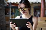 Portrait Of Thai Adult Student University Beautiful Girl Using Her Tablet Stock Photo