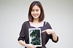 Portrait Of Thai Adult Student University Beautiful Girl Using Her Tablet Stock Photo