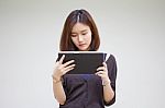 Portrait Of Thai Adult Student University Beautiful Girl Using Her Tablet Stock Photo