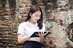 Portrait Of Thai Adult Student University Beautiful Girl Using Her Tablet Stock Photo