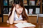 Portrait Of Thai Adult Student University Uniform Beautiful Girl Reading Red Book Stock Photo