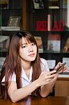 Portrait Of Thai Adult Student University Uniform Beautiful Girl Using Her Smart Phone Stock Photo