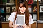 Portrait Of Thai Adult Student University Uniform Beautiful Girl Using Her Tablet Stock Photo