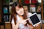 Portrait Of Thai Adult Student University Uniform Beautiful Girl Using Her Tablet Stock Photo