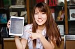 Portrait Of Thai Adult Student University Uniform Beautiful Girl Using Her Tablet Stock Photo