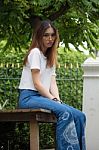 Portrait Of Thai Chinese Adult Glasses Beautiful Girl Denim Blue Bag Relax And Smile Stock Photo