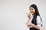 Portrait Of Thai High School Student Uniform Beautiful Girl Pointing Stock Photo