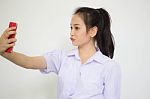 Portrait Of Thai High School Student Uniform Beautiful Girl Using Her Smart Phone Selfie Stock Photo