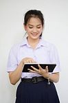 Portrait Of Thai High School Student Uniform Beautiful Girl Using Her Tablet Stock Photo