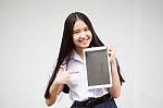 Portrait Of Thai High School Student Uniform Beautiful Girl Using Her Tablet Stock Photo