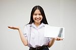 Portrait Of Thai High School Student Uniform Beautiful Girl Using Her Tablet Stock Photo