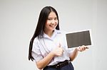 Portrait Of Thai High School Student Uniform Beautiful Girl Using Her Tablet Stock Photo