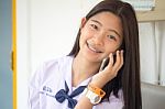 Portrait Of Thai Student Teen Beautiful Girl Using Her Phone And Smile Stock Photo