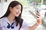 Portrait Of Thai Student Teen Beautiful Girl Using Her Phone And Smile Stock Photo